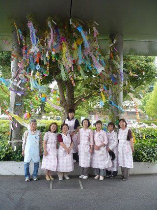 笹飾りと記念撮影するボランティア会の様子